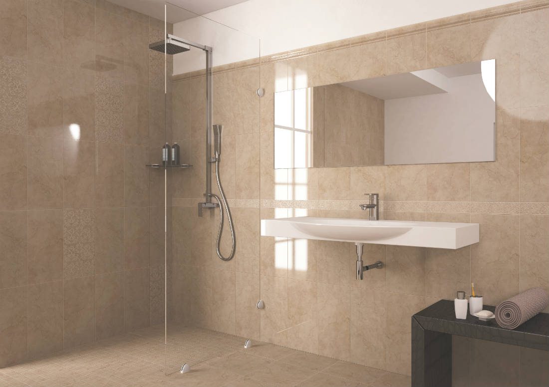 Bathroom with beige stone-look shower tiles with subtle patterned tiles sprinkled in