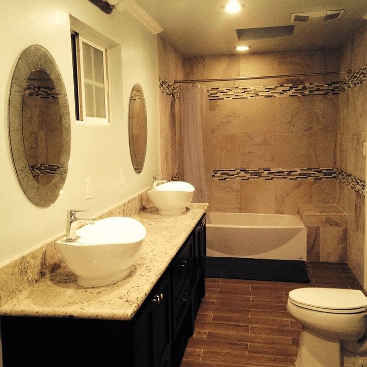 Click to Expand our Shower Tile Ideas Gallery 🔍 Bathroom shower tile ideas with stone-look walls, bold mosaic accent stripes and coordinating wood-look floor tile