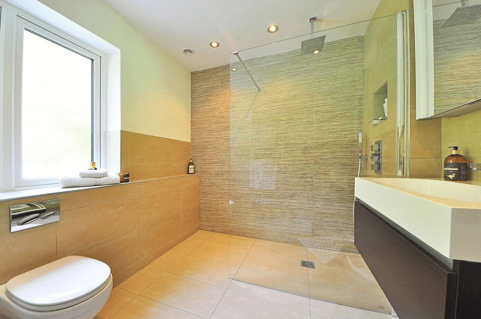Curbless shower tile ideas with textured accent wall and minimalist beige floor tile flowing into bathroom