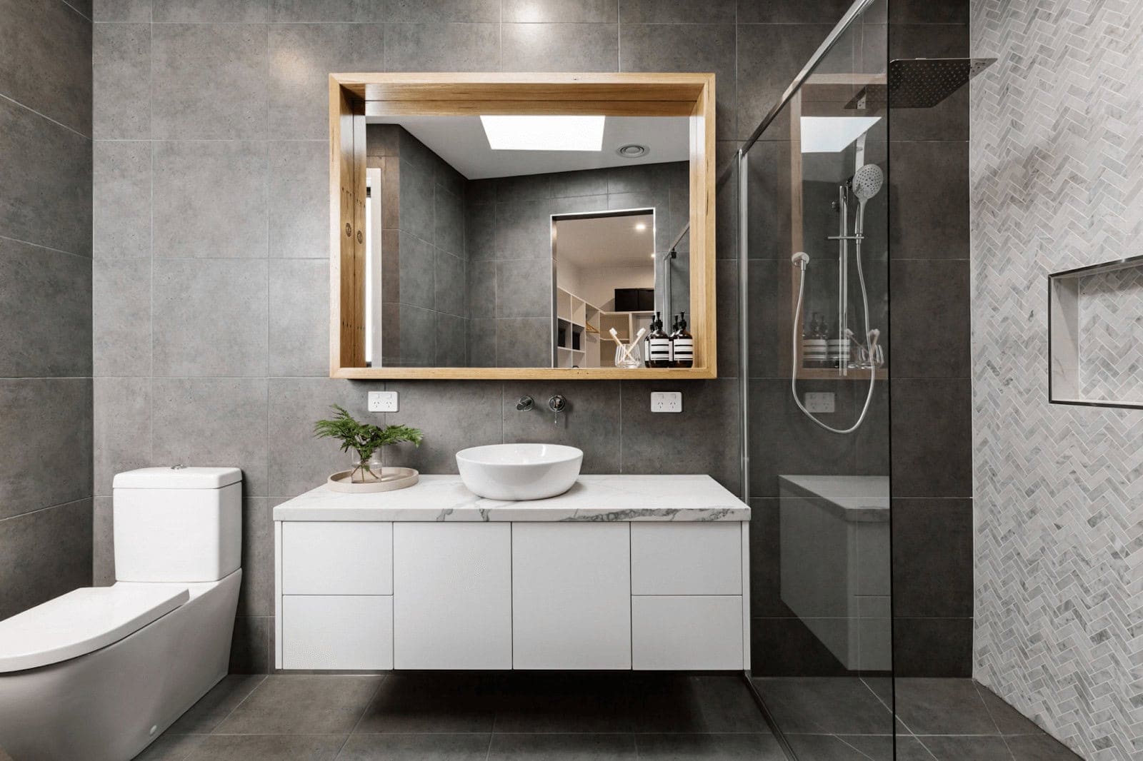 Click to Expand our Shower Tile Ideas Gallery 🔍 Shower tile designs with hand-painted floral ceramic mural feature wall framed in black trim and stone-look surrounding tiles