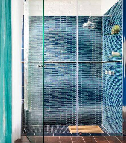 Click to Expand our Shower Tile Ideas Gallery 🔍 Shower tile ideas with floor-to-ceiling blue mosaic linear glass tiles in multiple shades