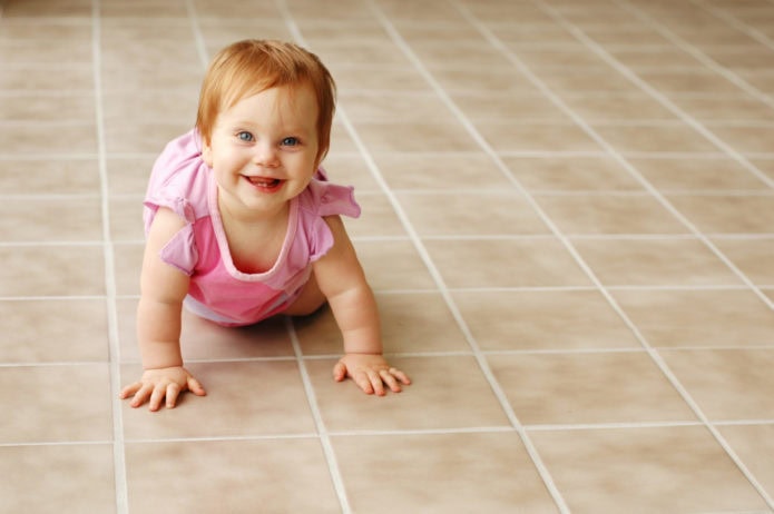 Baby crawling on tile