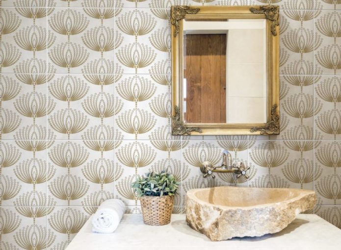 Wallpapered-look bathroom backsplash tile with a gold design