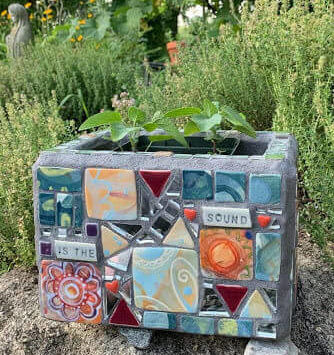Hand-painted planter box made by Kathy Casper with ceramic tile and mirrors