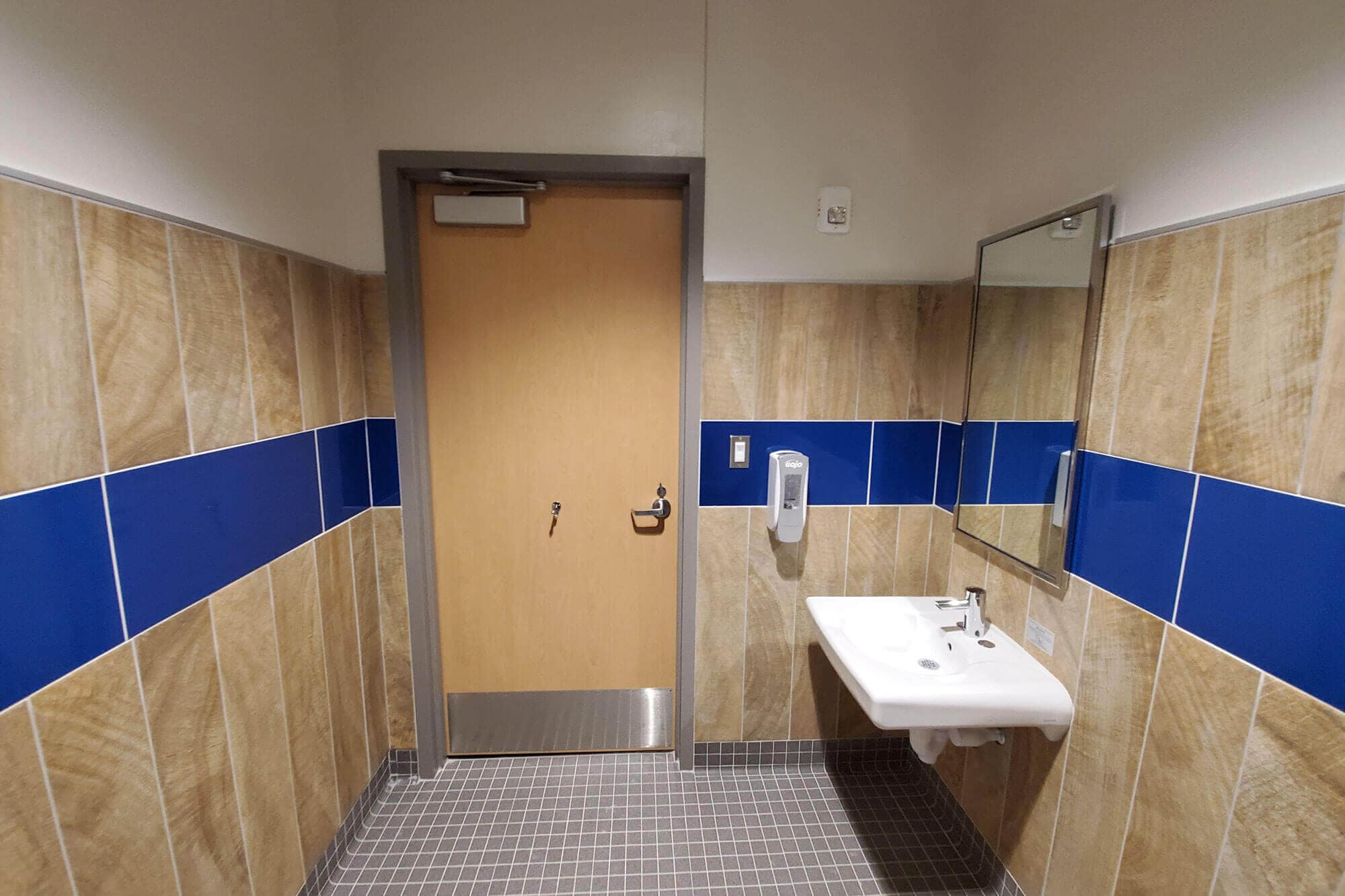 Bathroom with tan and blue tiling