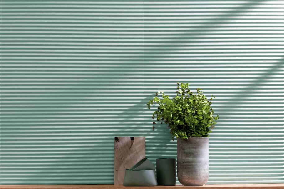 Textured muted green tile wall