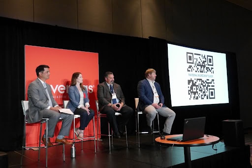 A panel at Coverings 2021 with a QR code shown on a screen