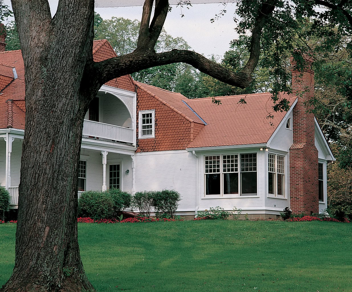 Residential home featuring porcelain and ceramic tile roofing