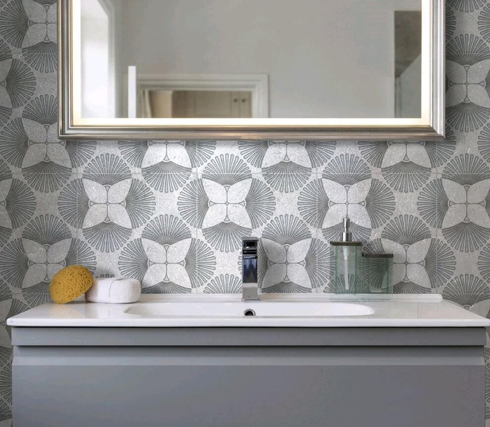 Bathroom sink with gray tile with a floral pattern


