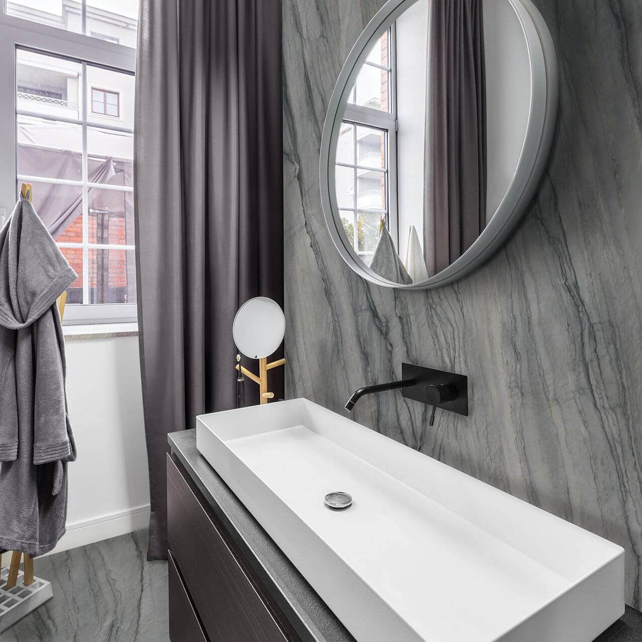 Luminous sink bathroom with gauged porcelain tile backsplash in a gray marble look
