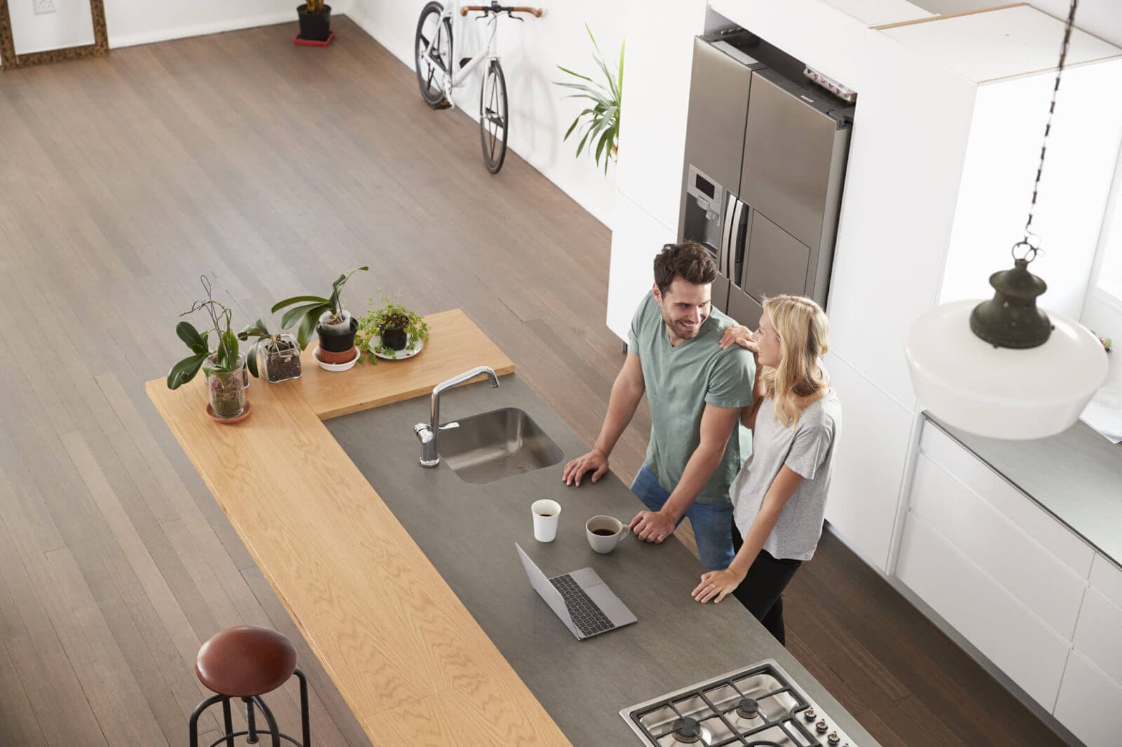 Couple smiling and talking in kitchen island