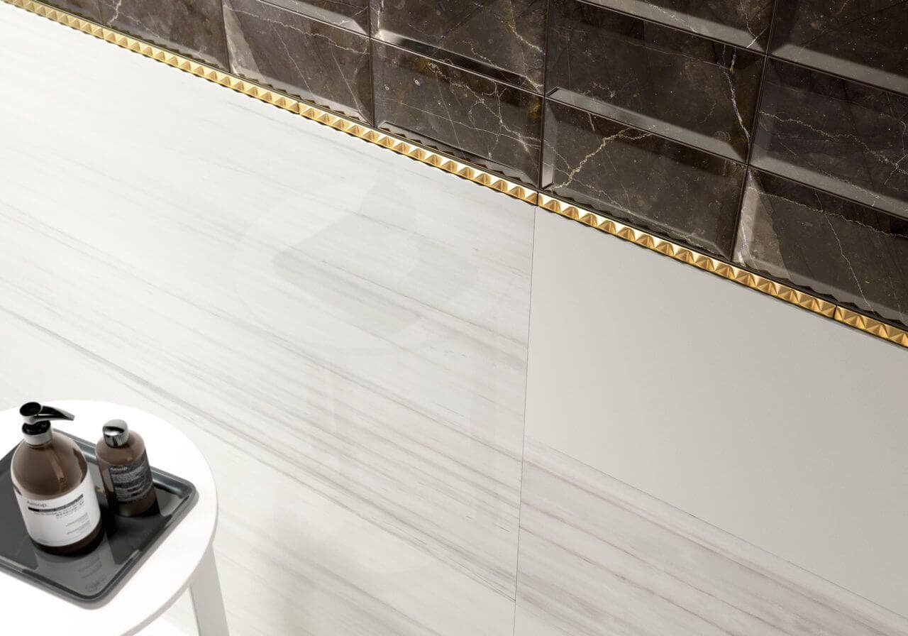 Three-dimensional gold tile accent border for powder room
