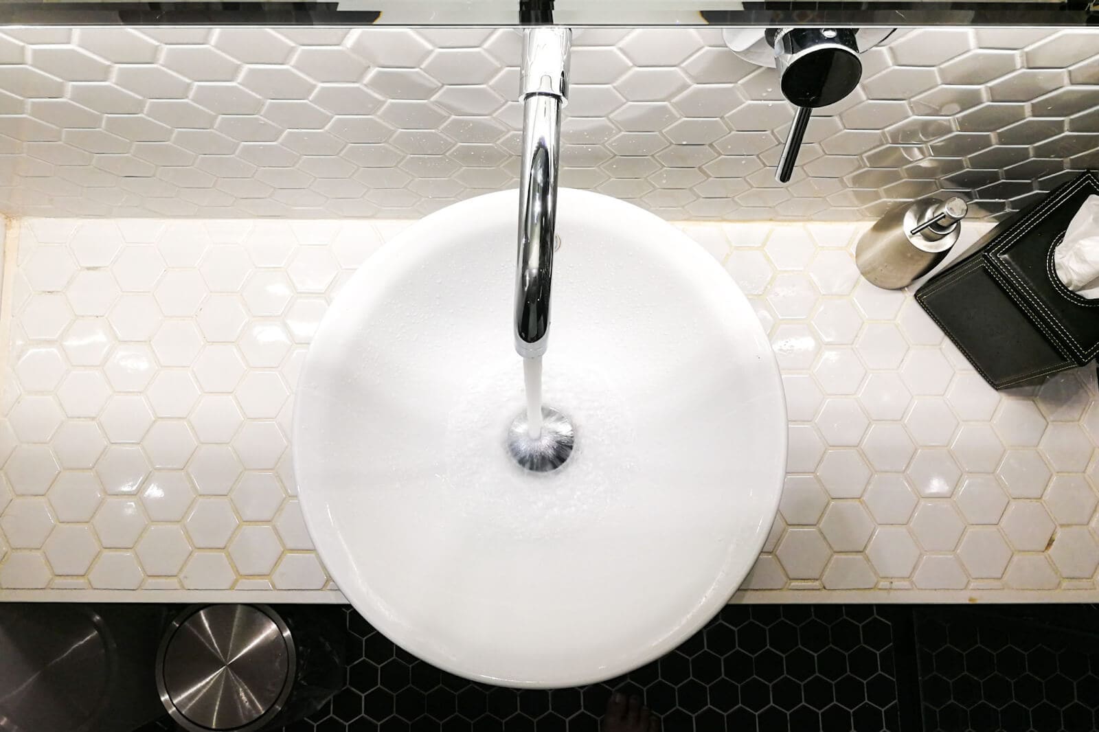 bathroom sink with white ceramic tile backsplash