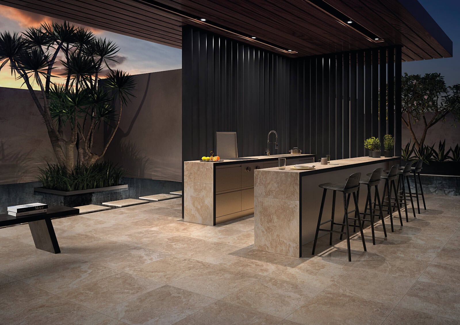 An open, outdoor kitchen with stone-look tile countertops and floors.