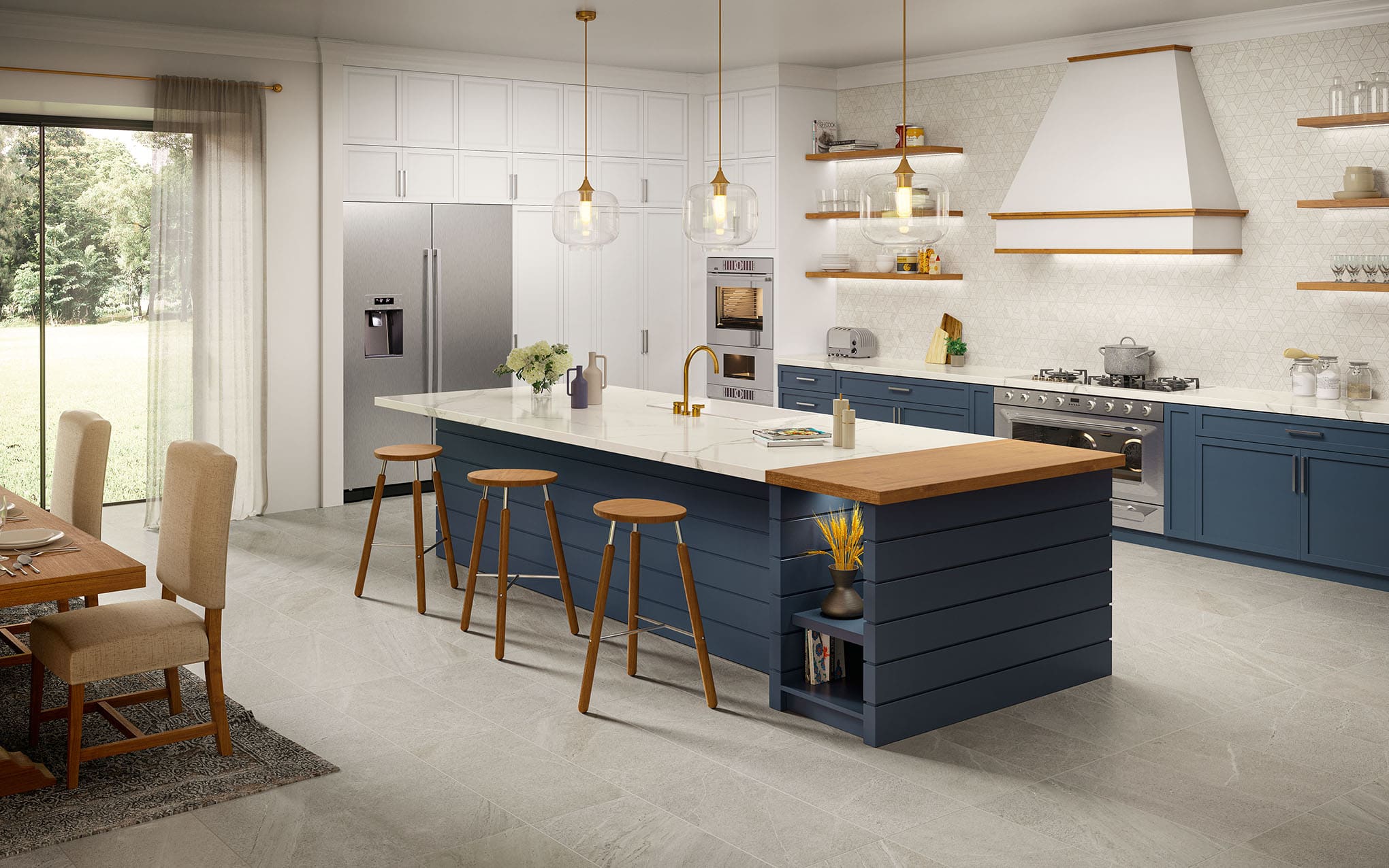 A bright kitchen with blue cabinetry and a white marble-look counter atop a kitchen island.