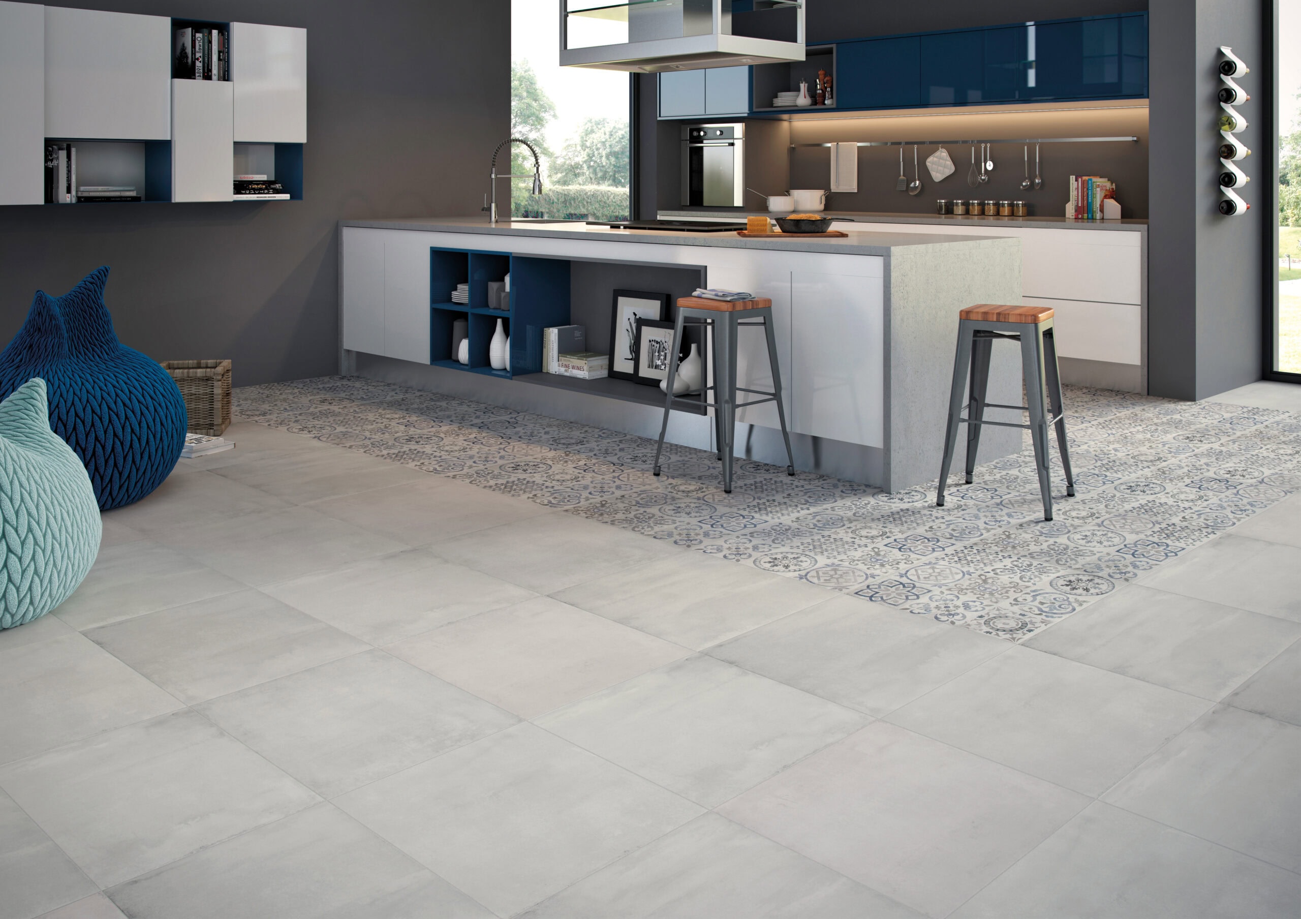 A modern kitchen with geometric tile floors and a gray tile kitchen island countertop.