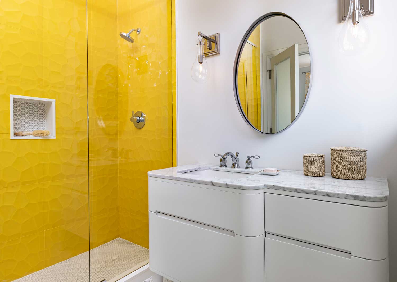 Penny round tile backs this classic shower niche, framed with smooth white profiles, contrasting with lemon-yellow shower walls while echoing the floor's pattern for a cheerful, sunny look