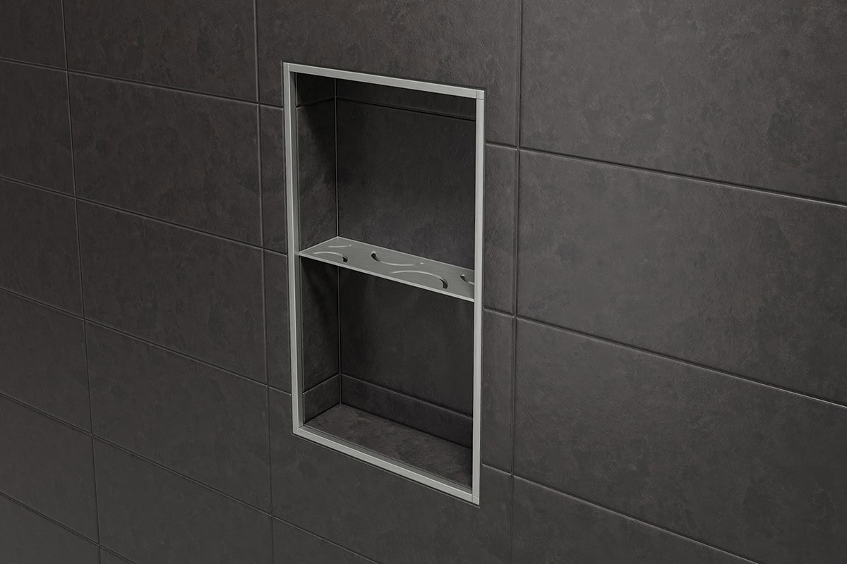 Slate-gray stone-look tile creates clean lines, with metal profiles framing the niche and coordinating with a metal shower shelf