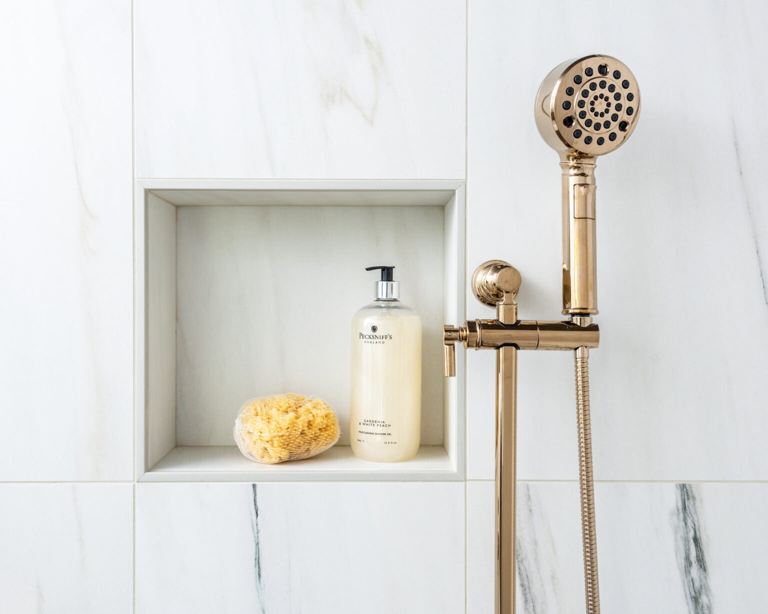 Classic marble-look tile in single square shower niche