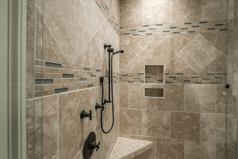 Corner shower with a built in shower bench and mosaic-tiled accent wall