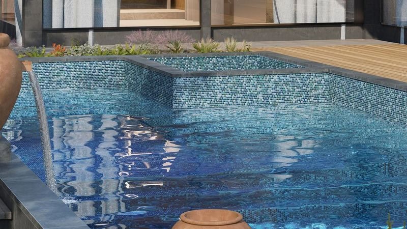 Exterior pool with penny round mosaics in rich blues and greens