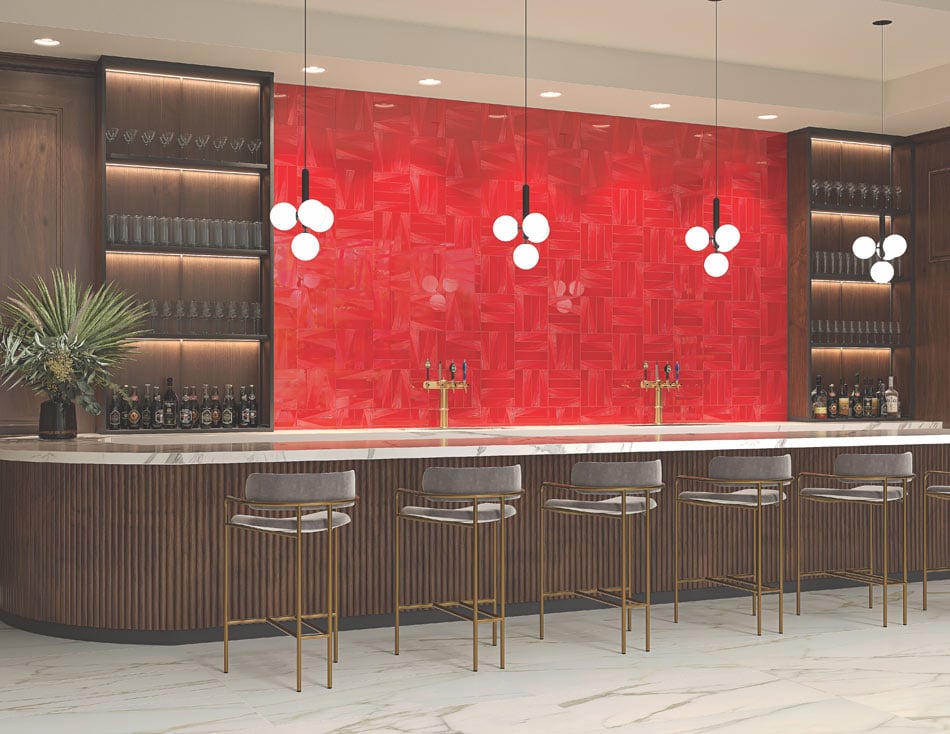 Modern bar interior with colorful wall tile, a glossy cherry tile backsplash behind a white marble counter and bar stools