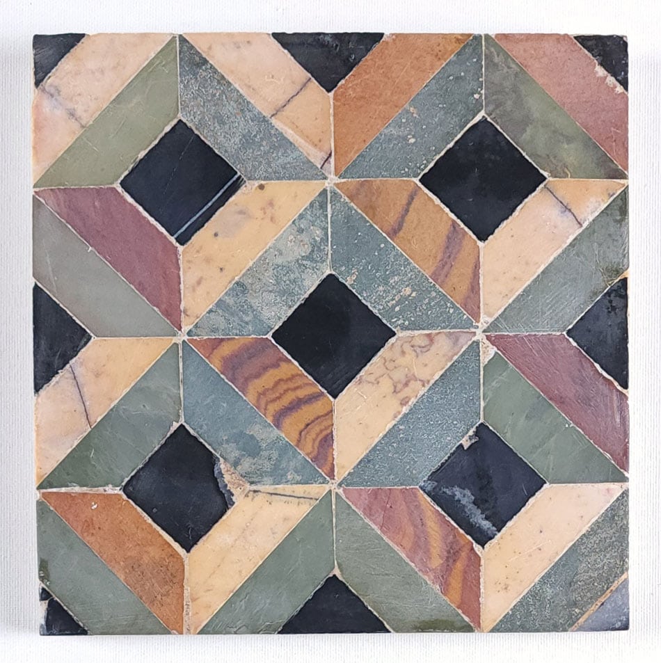 Colorful Tile Close-ups: Geometric mosaic of diamond-shaped ceramic tiles in black, green, rust and beige.