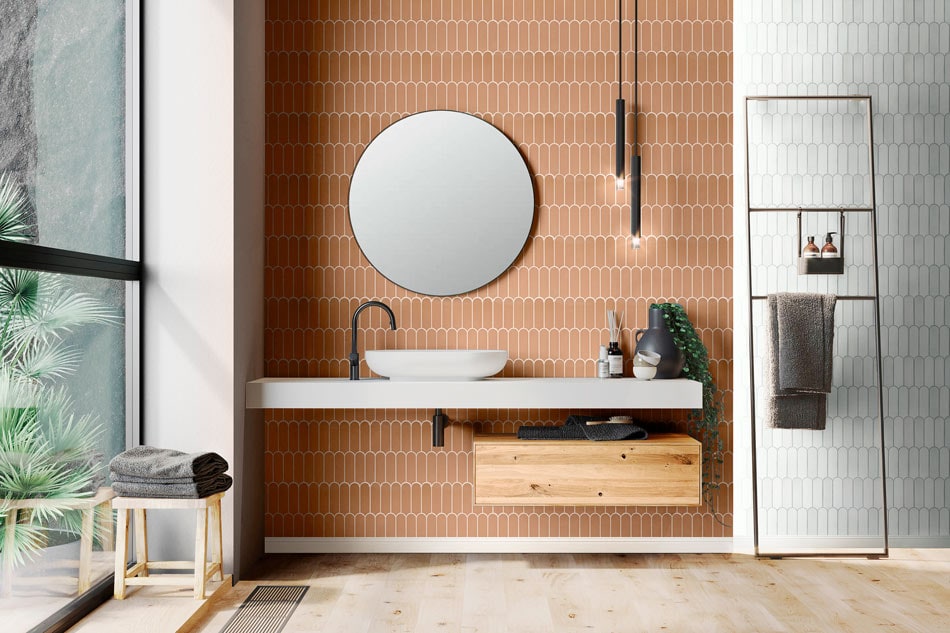 Bathroom vanity with oval mirror and peach-beige arched subway tile backsplash