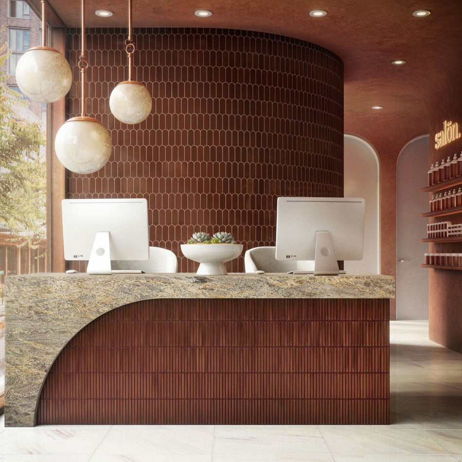 Reception area with glossy rust-brown narrow tile walls and a curved marble desk