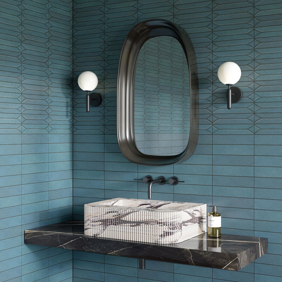 Powder room with rich aquamarine vertical subway tiles, black marble sink, and oval mirror