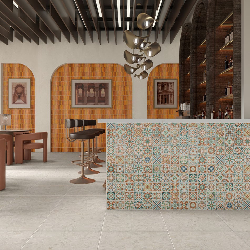 Bar lounge with colorful orange tile accent walls in arches and a colorful mosaic tile bar face