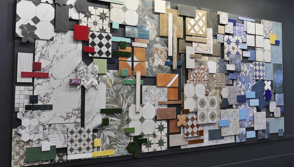 Collage art installation of assorted tile samples in diverse shapes, patterns, and colors