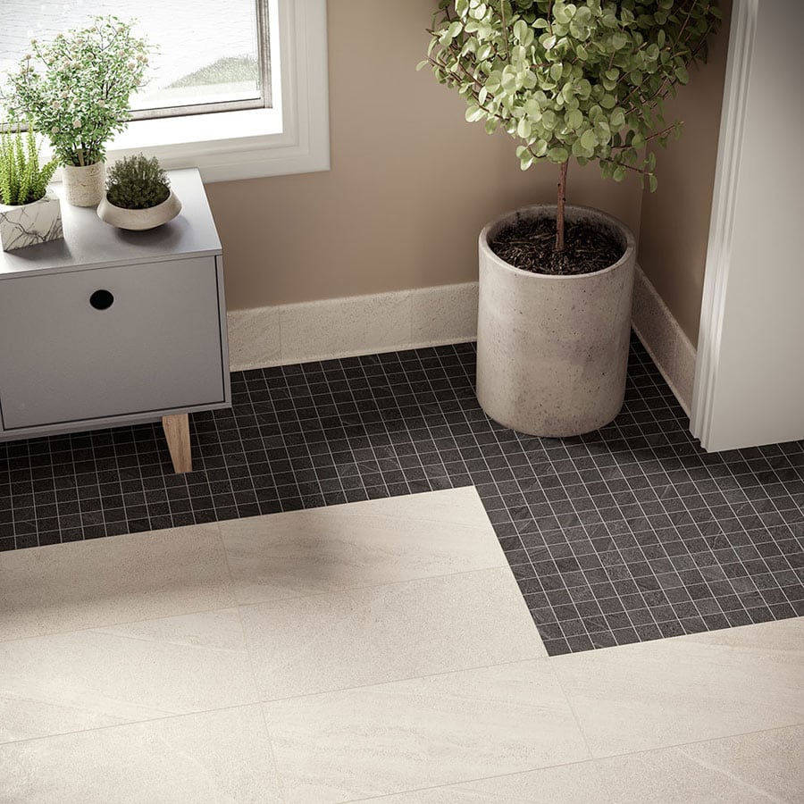 Interior corner with ivory stone-look floor tile bordered by black mosaic tile bands 