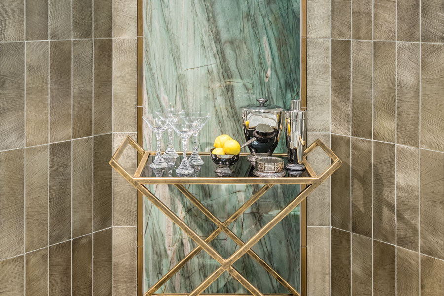 Bar cart set against an abalone-inspired green tile panel bordered by taupe ribbon tiles in a coursing layout