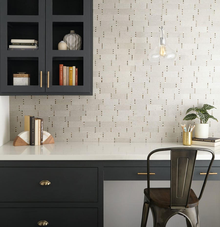 Home office with eggshell terrazzo-look wall tile accented by vertical mosaic tile courses