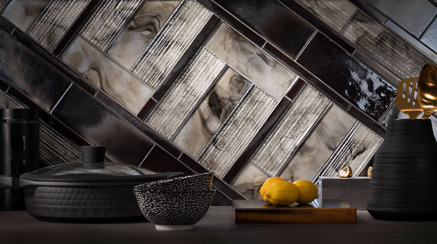 Backsplash with diagonal mixed tile coursing, glossy black zellige and smoky glass tiles