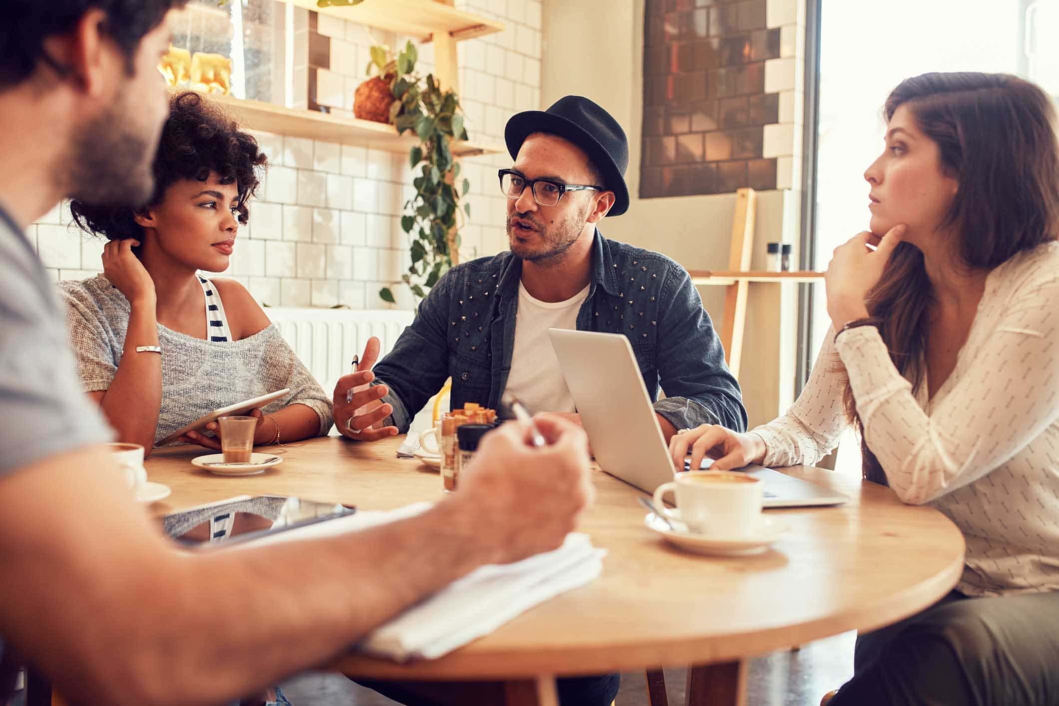 People meeting in a modern coffee shop with brown ceramic tile flooring