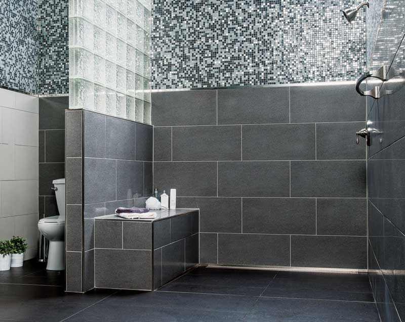 Mosaic and subway tile contrast in an industrial-style open bathroom