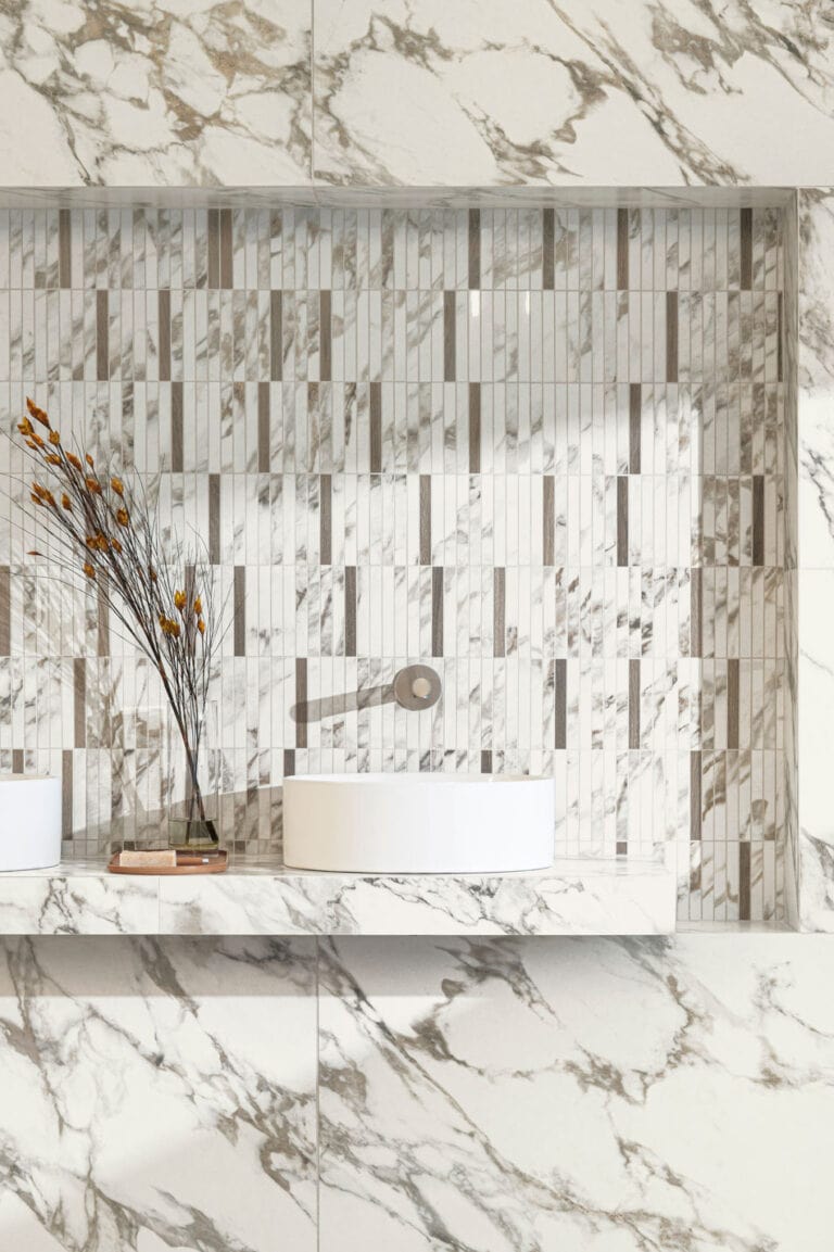 Random tile design in recessed bathroom backsplash with marble-look mosaic and wood-look accent tiles