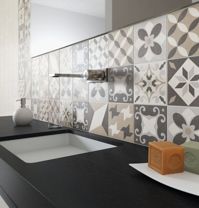 Random tile pattern bathroom backsplash with patterned encaustic-look tiles in neutral gray, beige and white
