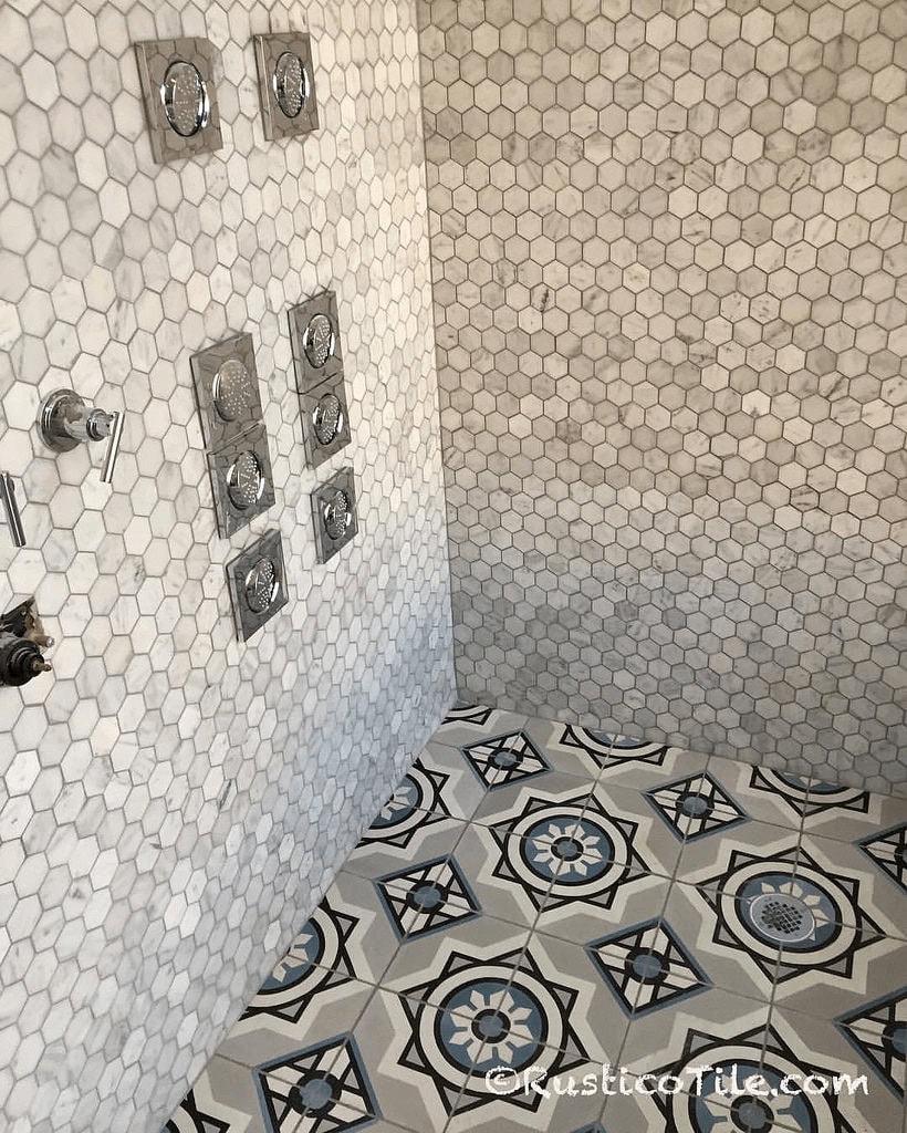 Shower floor tile ideas with modern Mexican pattern tiles and marble-look hexagon mosaic shower walls