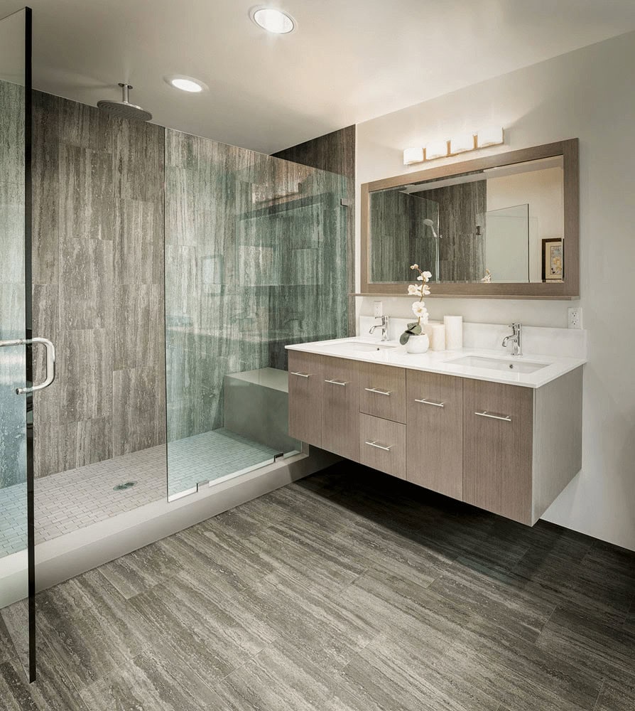 Shower tile ideas with greige wood-look wall tiles and white mosaic shower floor tile