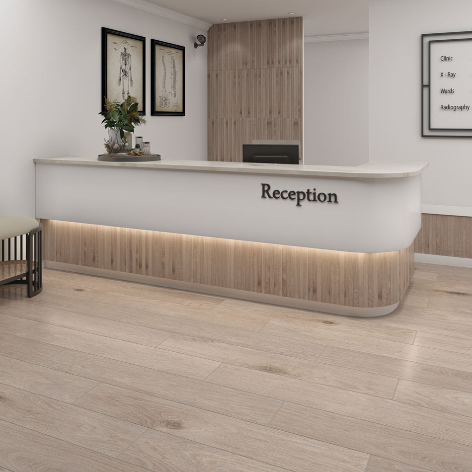 Reception area featuring fine-grained wood-look tile flooring and vertical wood-look tile framing the front desk