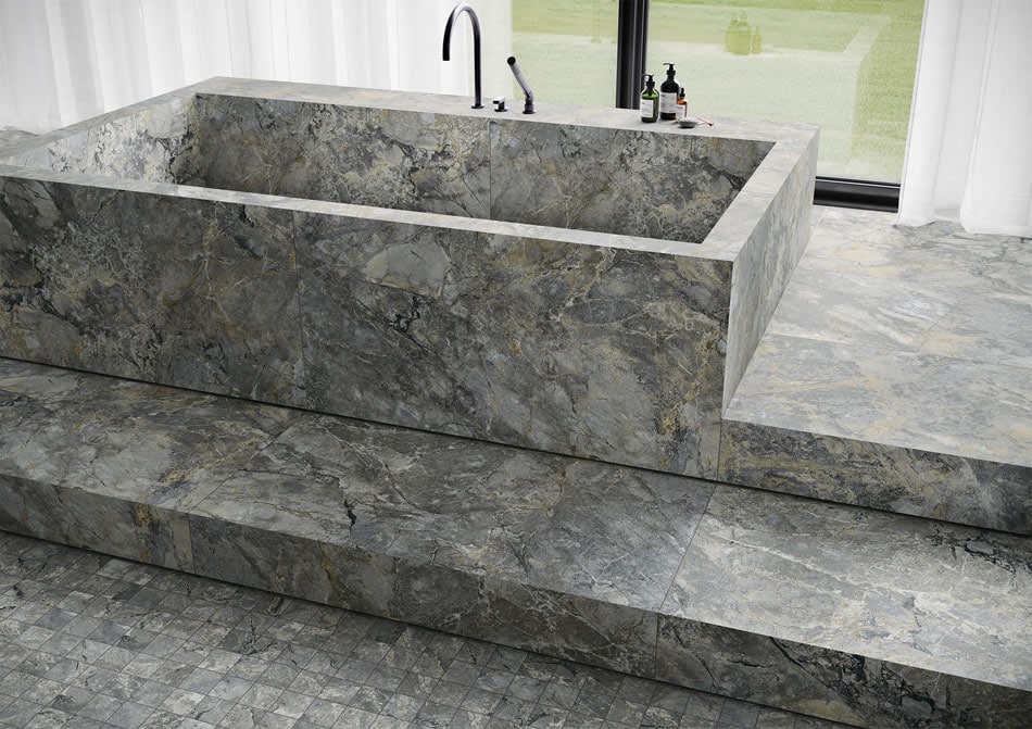Luxurious bathroom featuring marble-effect porcelain slabs and a grid mosaic floor with realistic veining textures