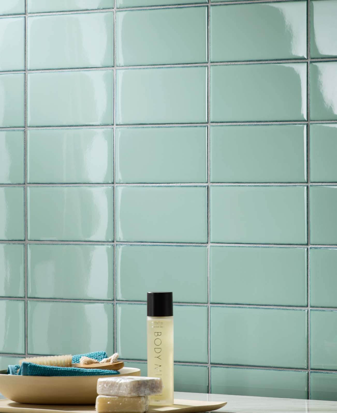 Personal hygiene items in front of Blue-green tile in a horizontal grid