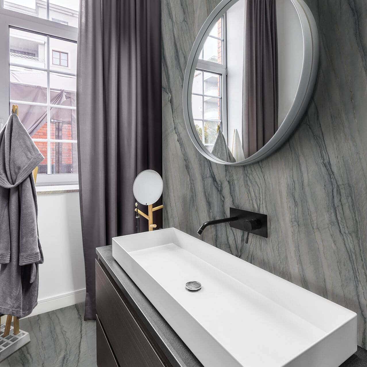 Luminous sink bathroom with gauged porcelain tile backsplash in a gray marble look