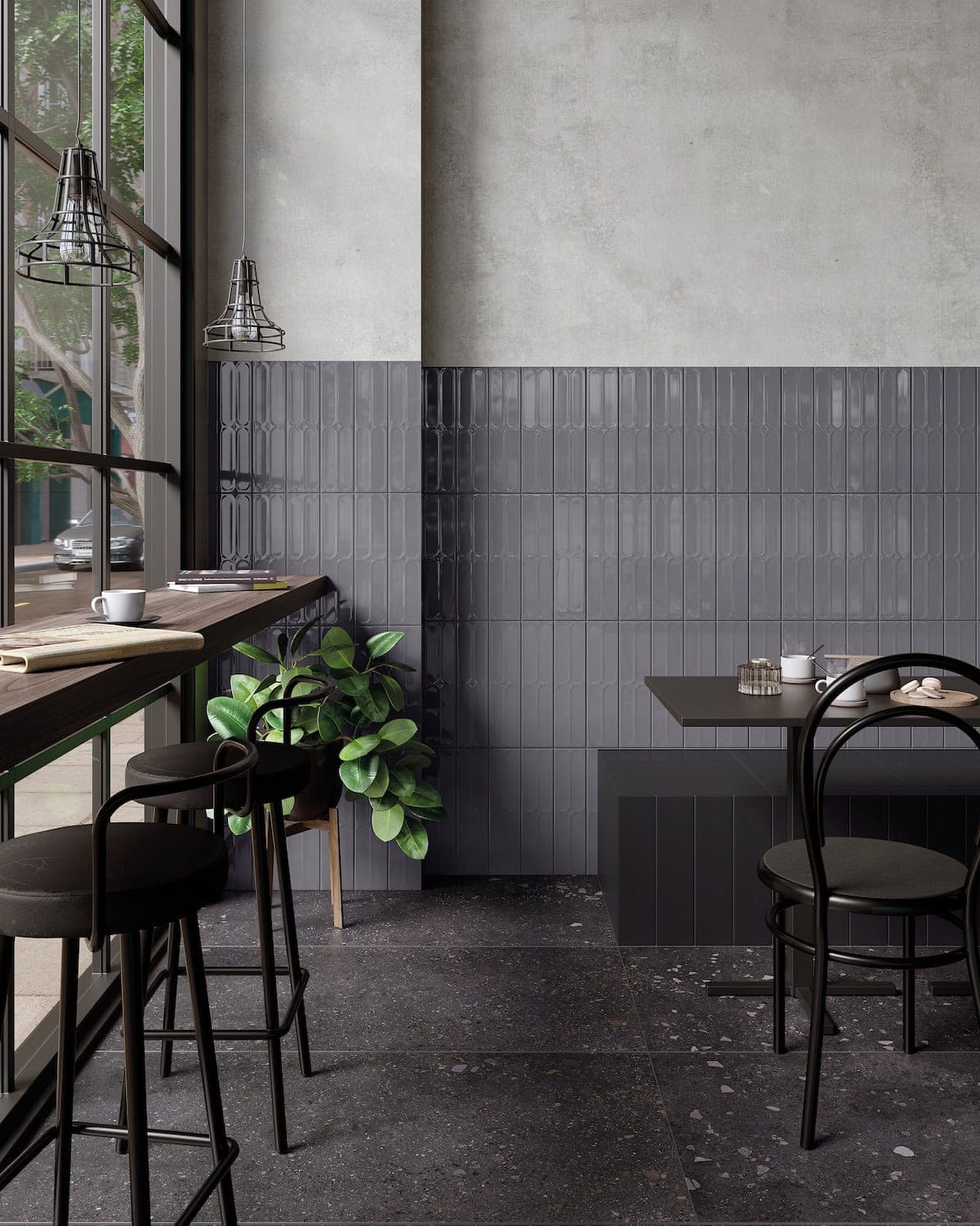 Cafe interior with black speckled stone-look floor tile and glossy gray 3D wall tile in a monochrome color-block design