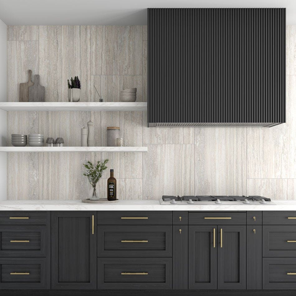 Elegant kitchen design with airy travertine-style porcelain tile backsplash and dark cabinetry with brass hardware