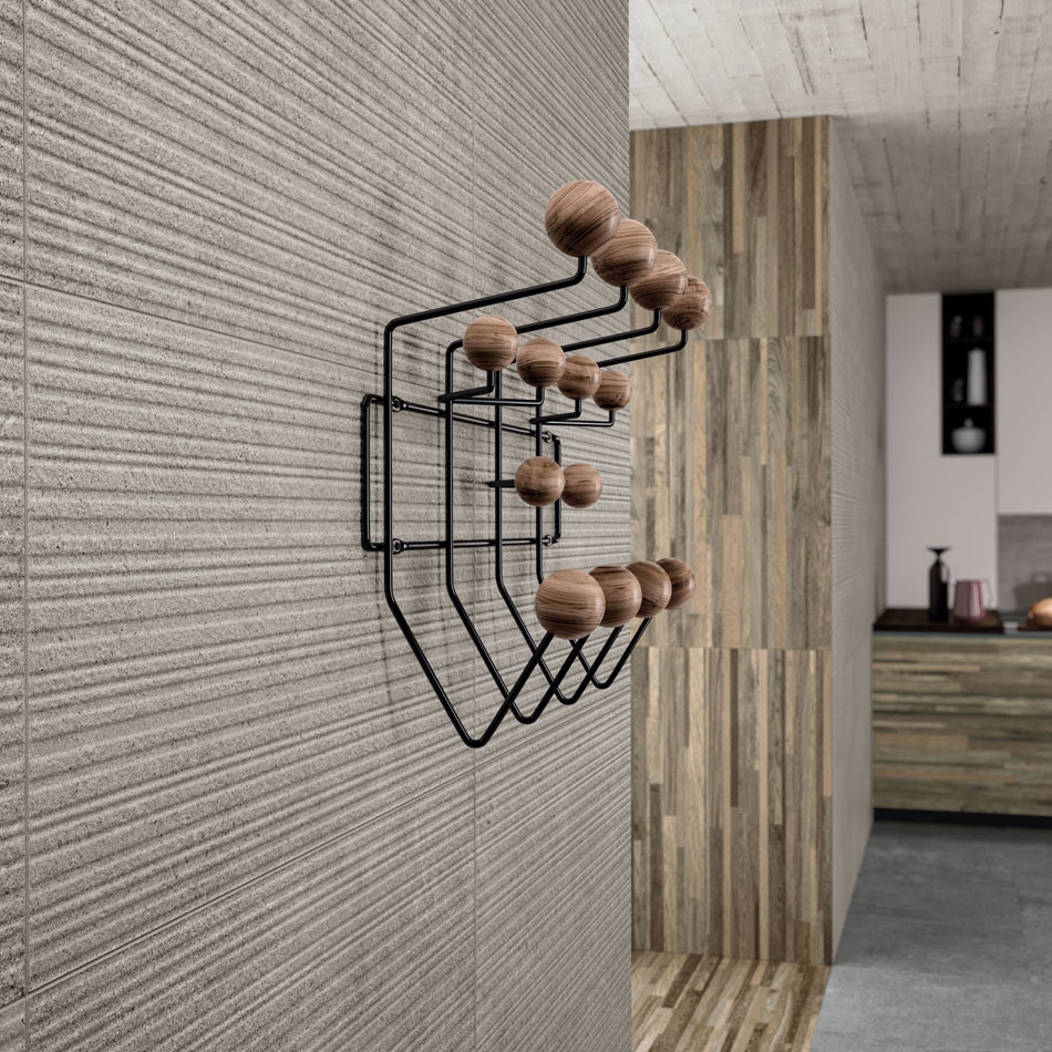 Fluted stone-look ceramic tile panels with fine grain texture in a midcentury modern entryway