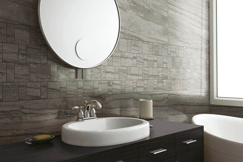 Bathroom sink with gray stone-look tile in small and large rectangles